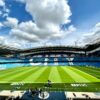A view of the iconic Etihad Stadium in Manchester, United Kingdom, showcasing its vibrant football field.