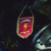 Liverpool FC pennant hanging inside a car, reflecting passion for football.