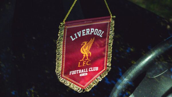 Liverpool FC pennant hanging inside a car, reflecting passion for football.