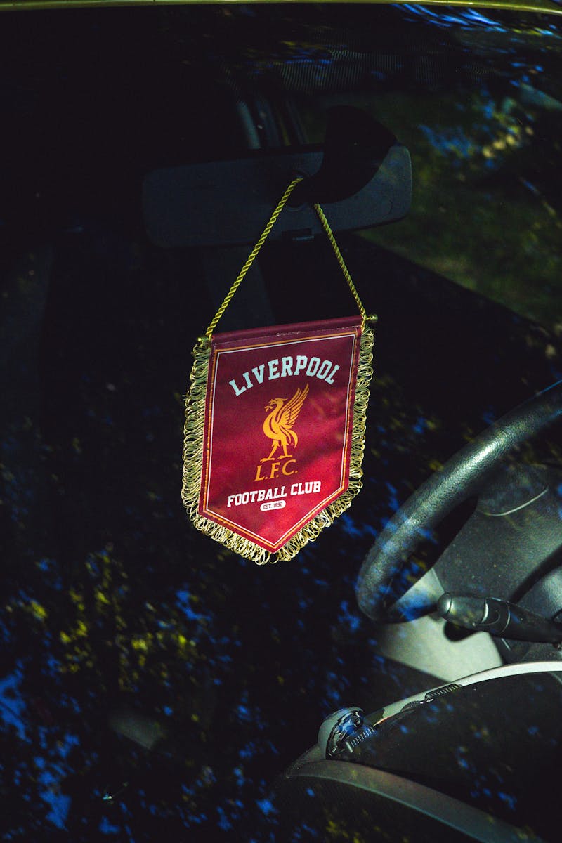Liverpool FC pennant hanging inside a car, reflecting passion for football.