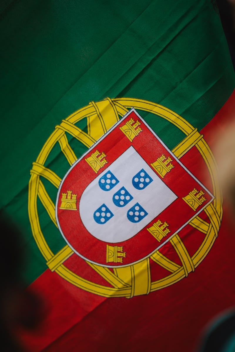 Vivid close-up image of the emblem on the Portuguese national flag with bright colors.