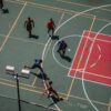Dynamic aerial shot of a fast-paced sports game on an outdoor multi-use court, showcasing action and teamwork.