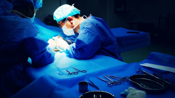 two surgeons performing surgery in a dark room