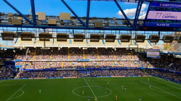 A lively football match in Stamford, England capturing the crowd and players in a filled stadium.