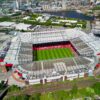 Stunning aerial shot of Old Trafford stadium in Manchester, showcasing its iconic architecture.
