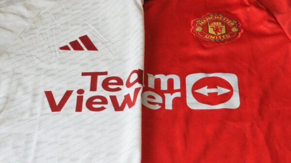Close-up of Manchester United 2023 jerseys showcasing red and white designs.