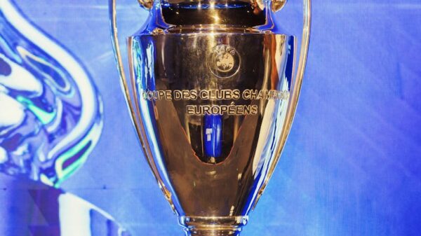 Close-up of the UEFA Champions League trophy on a pedestal indoors.