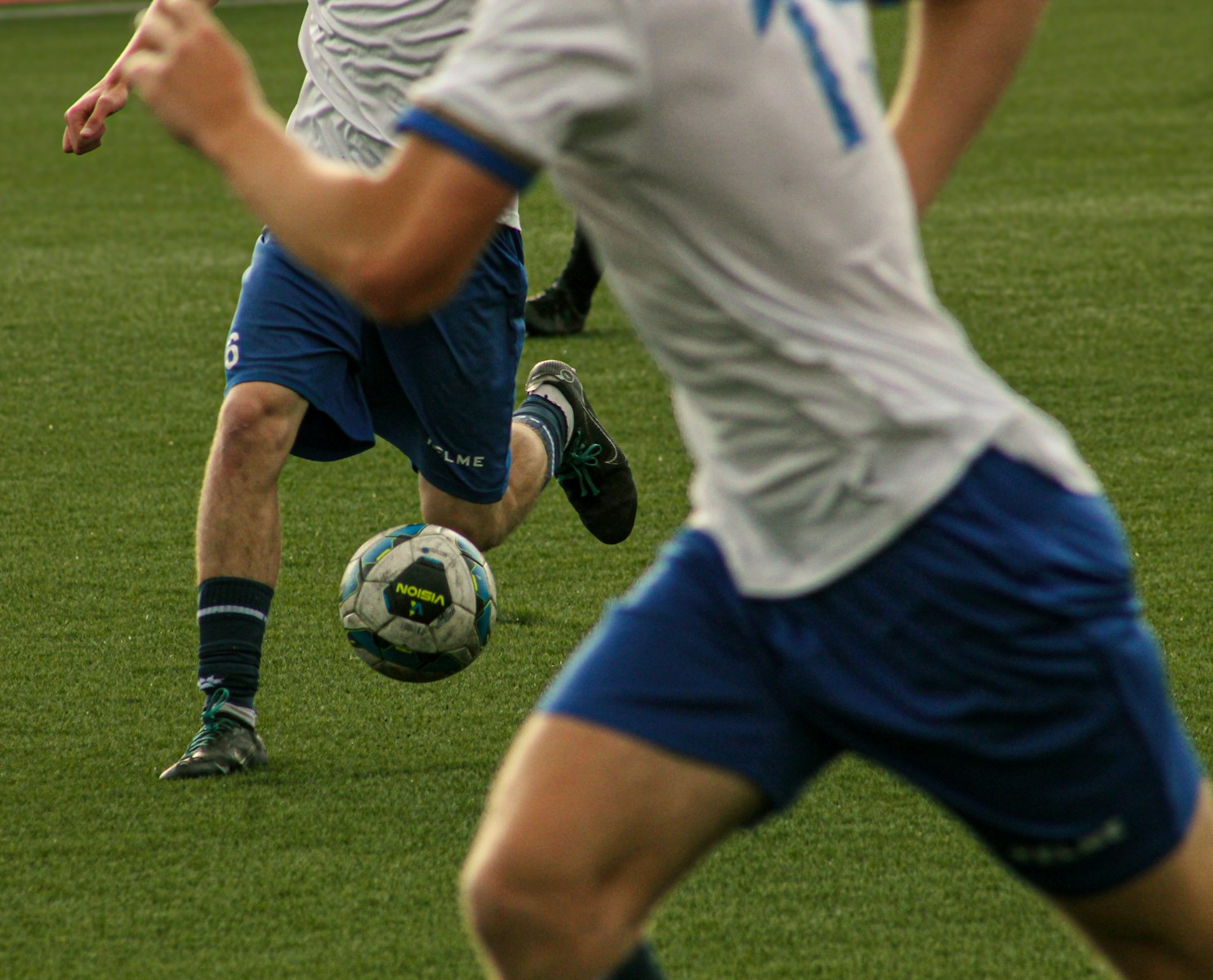Soccer players are shown during a match.