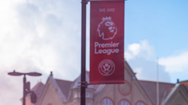 a group of people with pink smoke in front of a building