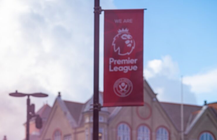 a group of people with pink smoke in front of a building