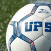 Detailed shot of a UPSL soccer ball on green grass, perfect for sports themes.