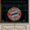 FC Bayern Store front in Munich showcasing the iconic Bayern Munich logo and architectural details.