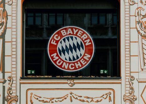 FC Bayern Store front in Munich showcasing the iconic Bayern Munich logo and architectural details.