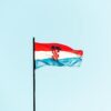 The national flag of Croatia waving against a blue sky in Trogir.