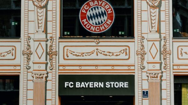 FC Bayern Store front in Munich showcasing the iconic Bayern Munich logo and architectural details.