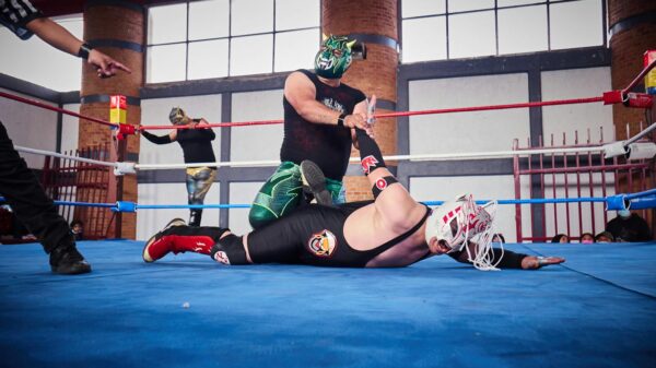 Masked wrestlers clash in an intense lucha libre match, showcasing athleticism and tradition.