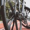 Detailed view of a bicycle wheel on a red urban bike path, showcasing modern design.