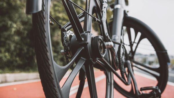 Detailed view of a bicycle wheel on a red urban bike path, showcasing modern design.