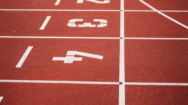 Close-up view of a red running track with numbered starting lanes, perfect for athletic themes.