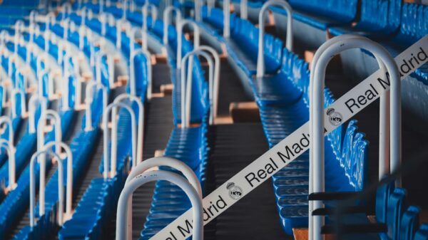 Rows of blue stadium seats in Madrid's iconic Bernabéu Stadium, featuring Real Madrid branding.