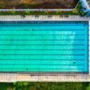 Drone shot of a vibrant swimming pool in Jawa Barat, Indonesia, showing clear turquoise water.