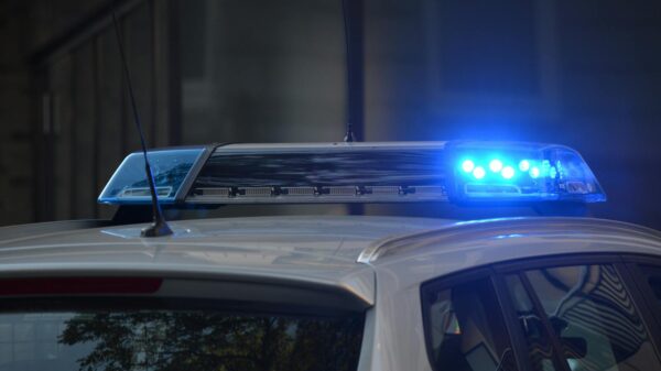Close-up of a police car's flashing blue lights in an urban environment.