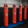Interior of boxing gym with heavy punching bags hanging on chains for workout