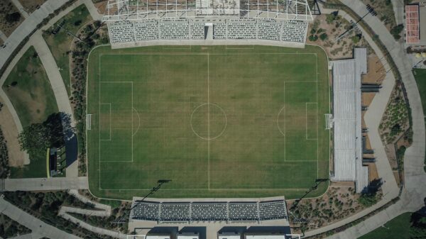 High-angle aerial shot capturing the details of a soccer stadium and surrounding sports complex.