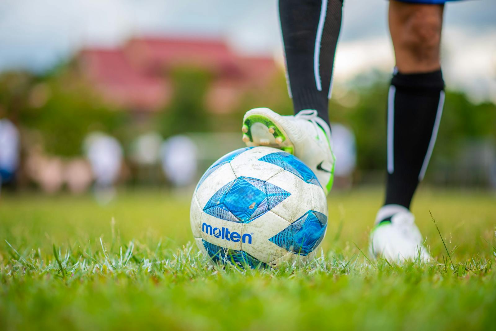 A detailed shot of a player’s foot on a soccer ball during a game, emphasizing sport and movement.