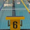 Indoor swimming pool with starting block number six, perfect for pool sports and training.