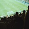 a crowd of people watching a soccer game