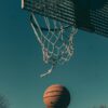 A basketball nearing the hoop on an outdoor court in London.