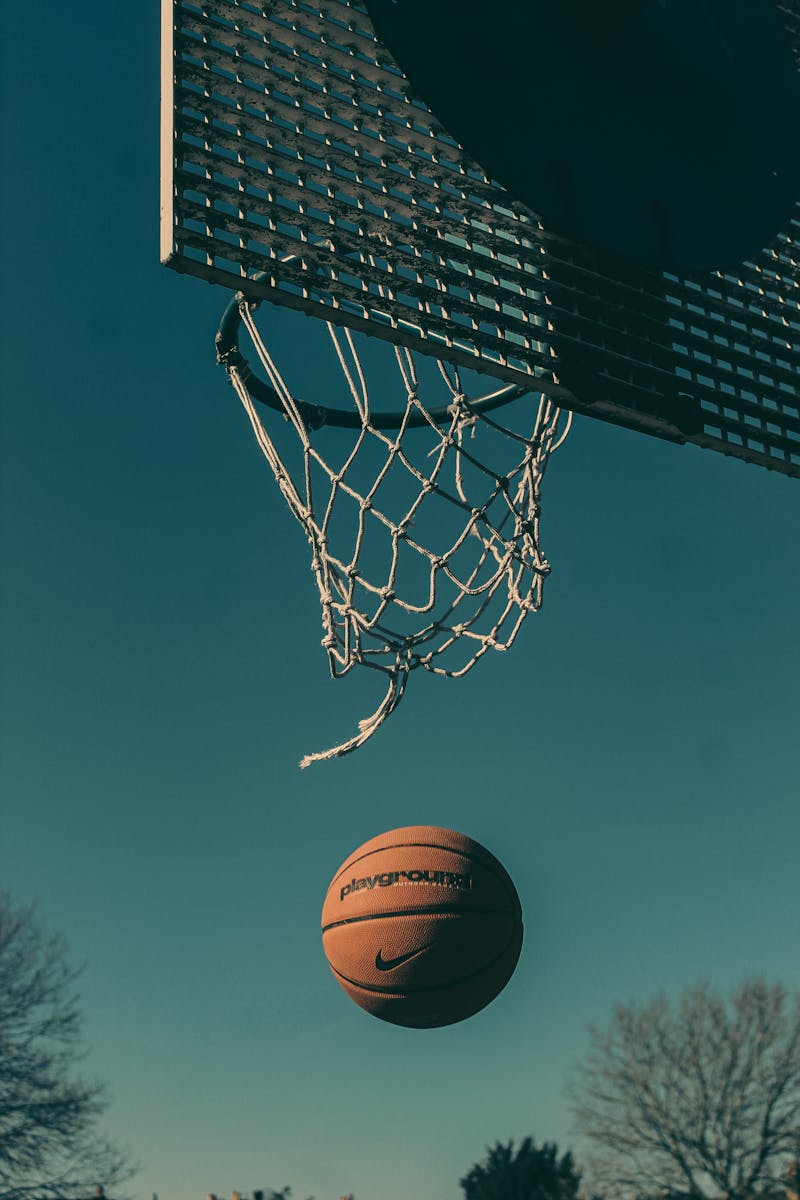 A basketball nearing the hoop on an outdoor court in London.