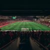 An exciting football match with passionate fans filling the stadium under bright lights, capturing sports energy.