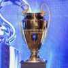 Close-up of the UEFA Champions League trophy on a pedestal indoors.