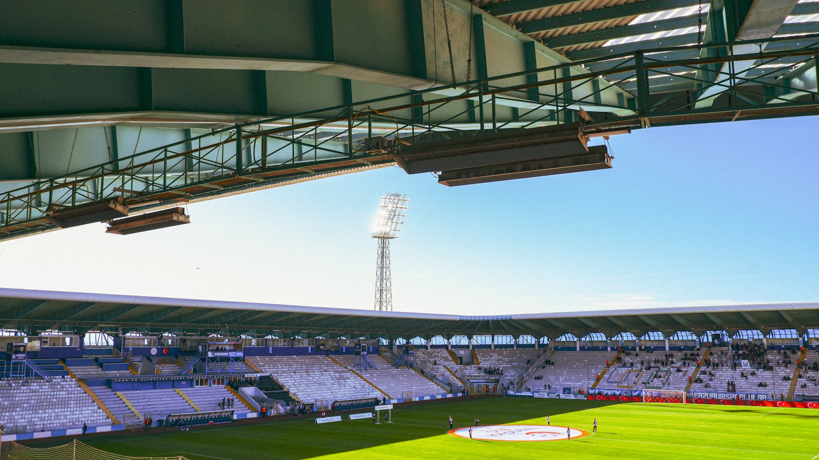 A wide-angle view of Kazim Karabekir Stadium in Erzurum during a soccer event with clear skies.