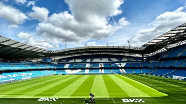 A view of the iconic Etihad Stadium in Manchester, United Kingdom, showcasing its vibrant football field.