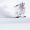 A skier in motion navigating a snowy slope with speed and precision during a winter sports event.