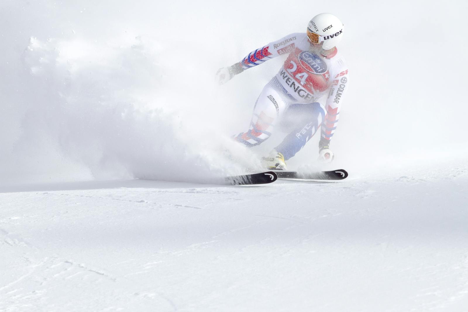 A skier in motion navigating a snowy slope with speed and precision during a winter sports event.