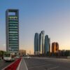 Stunning view of Abu Dhabi's skyline with skyscrapers and traffic at sunset.