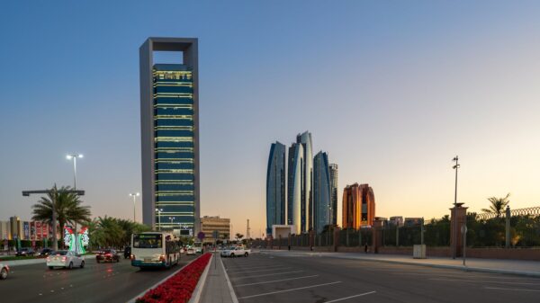 Stunning view of Abu Dhabi's skyline with skyscrapers and traffic at sunset.