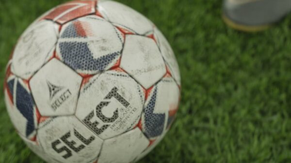 A close-up of a soccer ball on a lush green field, perfect for sports enthusiasts.
