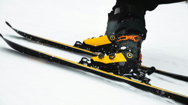 person in black jacket and black pants riding on snowboard during daytime