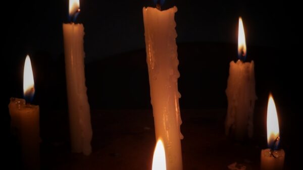 a group of lit candles sitting on top of a table