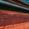 Close-up of empty seats at Emirates Stadium, capturing the iconic red seating of Arsenal's home ground.