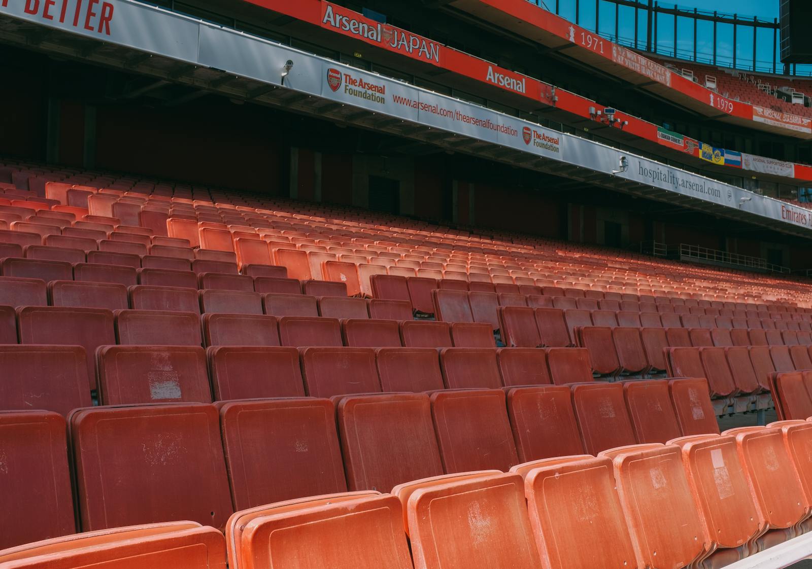 Close-up of empty seats at Emirates Stadium, capturing the iconic red seating of Arsenal's home ground.