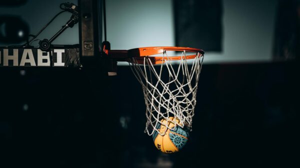 Dramatic basketball dunk captured in Abu Dhabi sports arena.