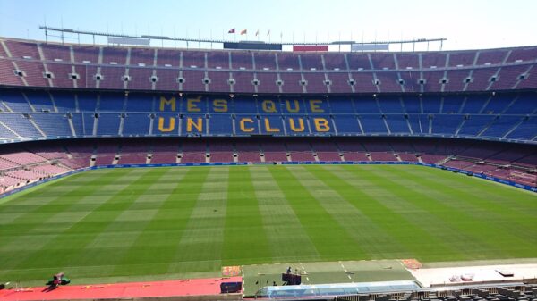 Panoramic view of Camp Nou stadium in Barcelona, home of FC Barcelona football team, with 'Mes Que Un Club' slogan.