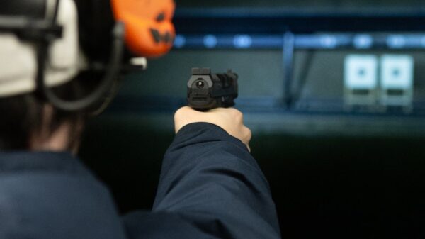 A man pointing a gun at the camera