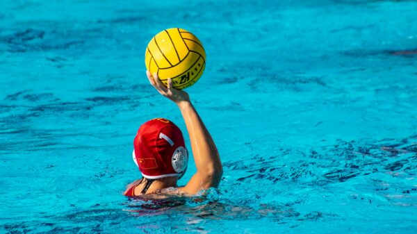 a person in a pool with a ball in their hand